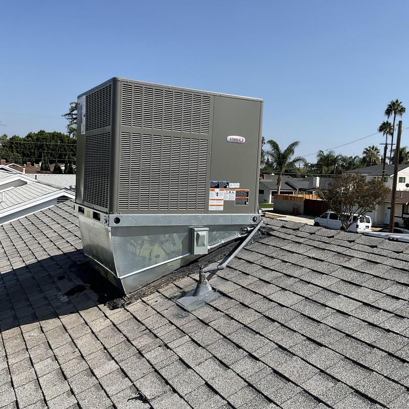 Package unit HVAC system on residential roof with new ducting