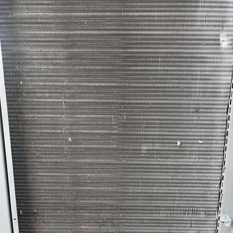 Air conditioner condenser coil with minor debris buildup Air conditioner condenser coil with minor debris buildup