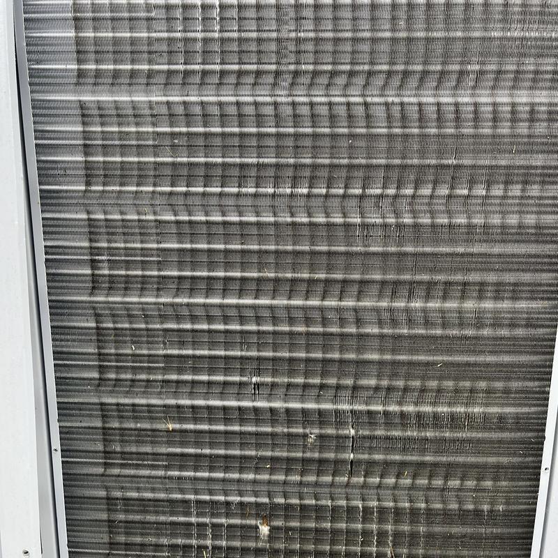 Outdoor air conditioner condenser coil close-up, maintenance