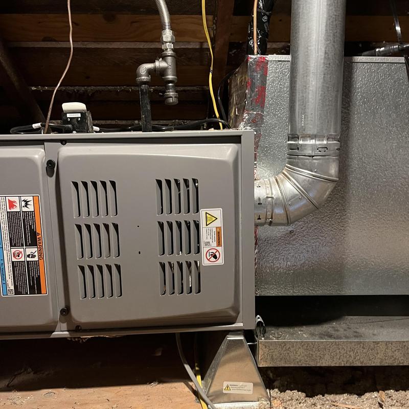 Furnace unit with metal ductwork in basement