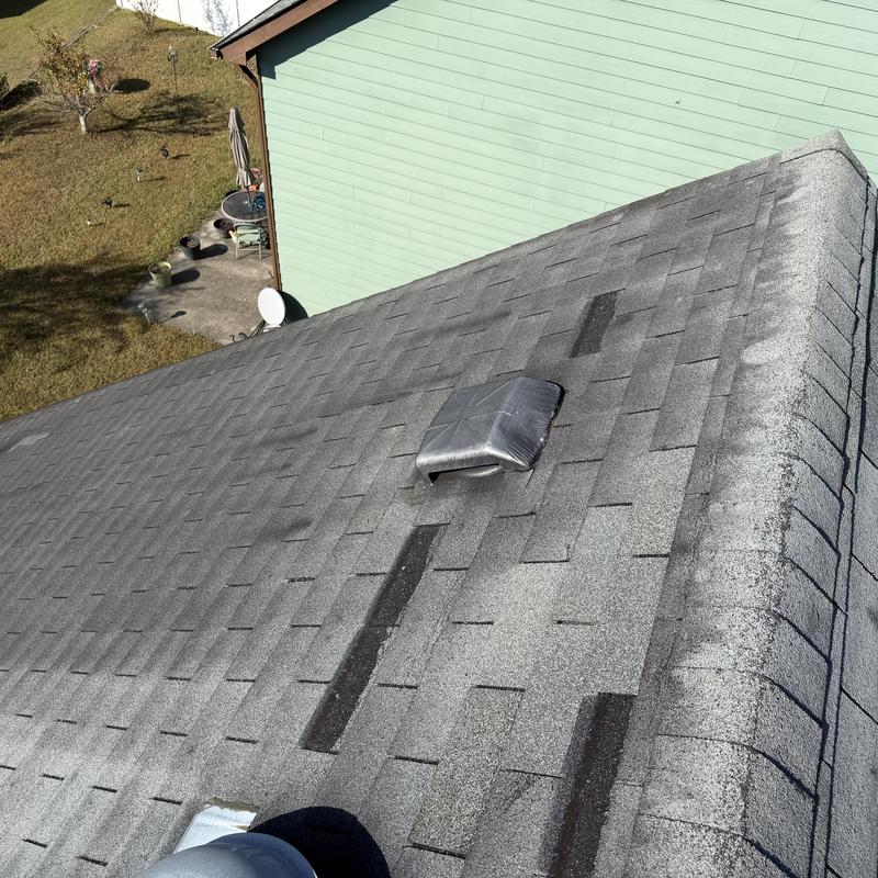 Asphalt roof shingles with patches and vent pipe