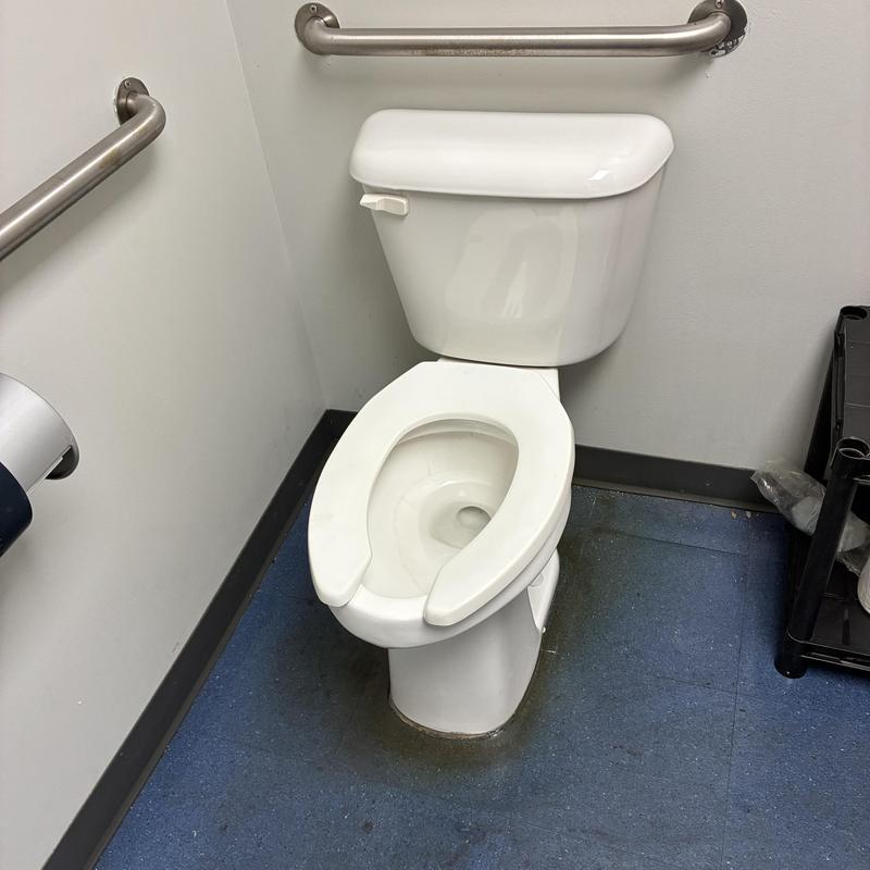 Toilet with open-front seat in commercial restroom