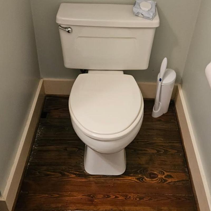 Toilet flange installation with new toilet in bathroom