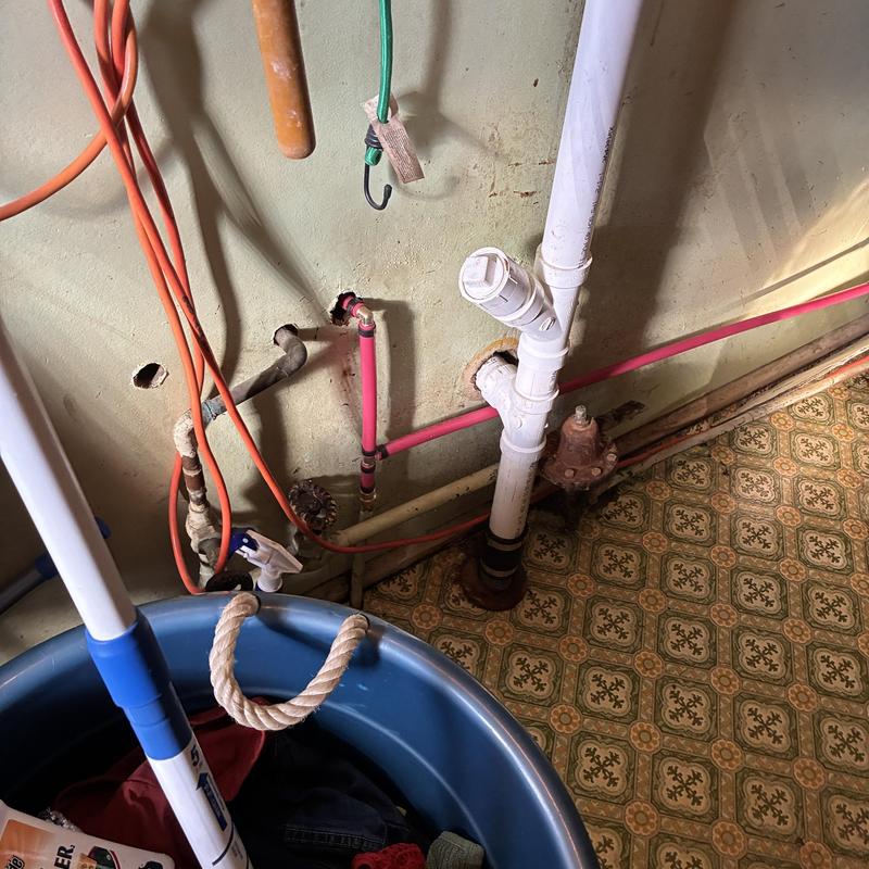 12-inch hot water pipe with leak repair near drainpipe