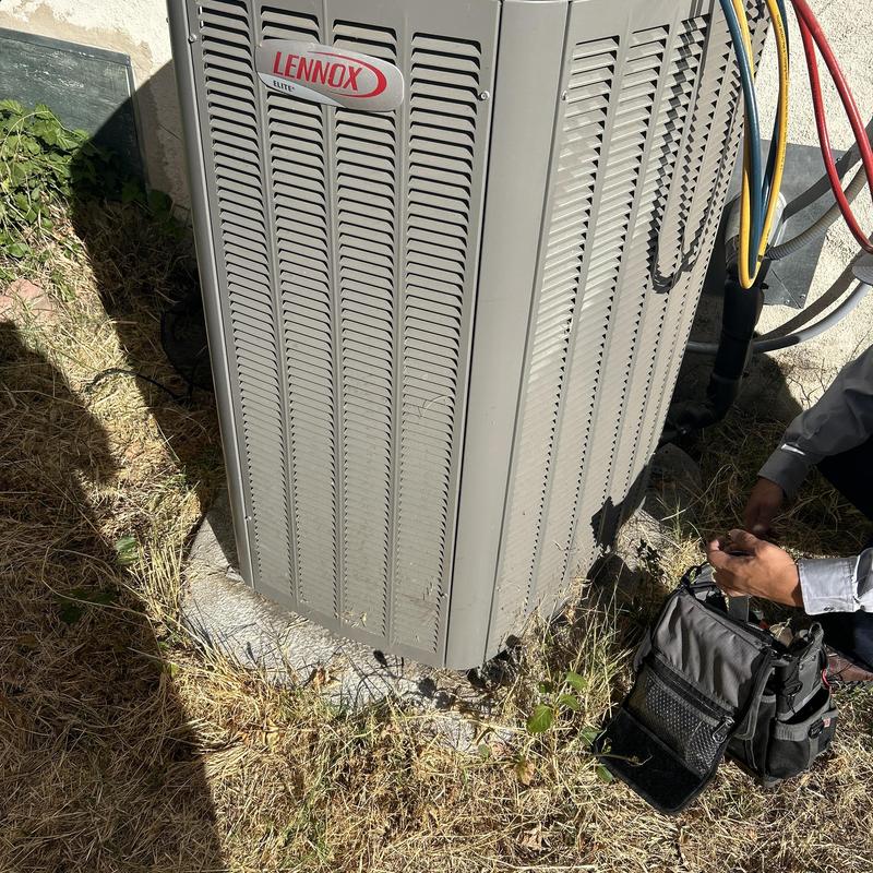 Lennox outdoor AC unit with technician tools nearby