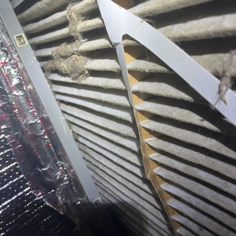 HVAC air filter clogged with dust and debris