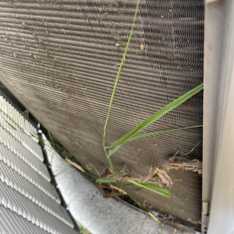 Air conditioner coil with debris and grass buildup