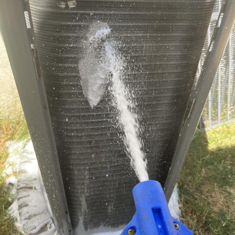 Air conditioner coil cleaning with water spray