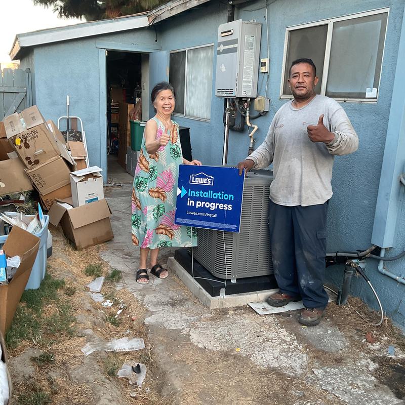ML14KC1 condenser installation with homeowners outdoors
