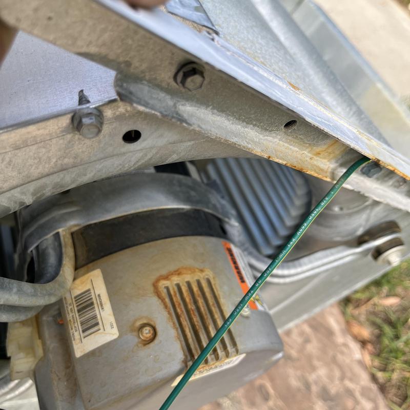 Blower motor unit with rust on housing near frame