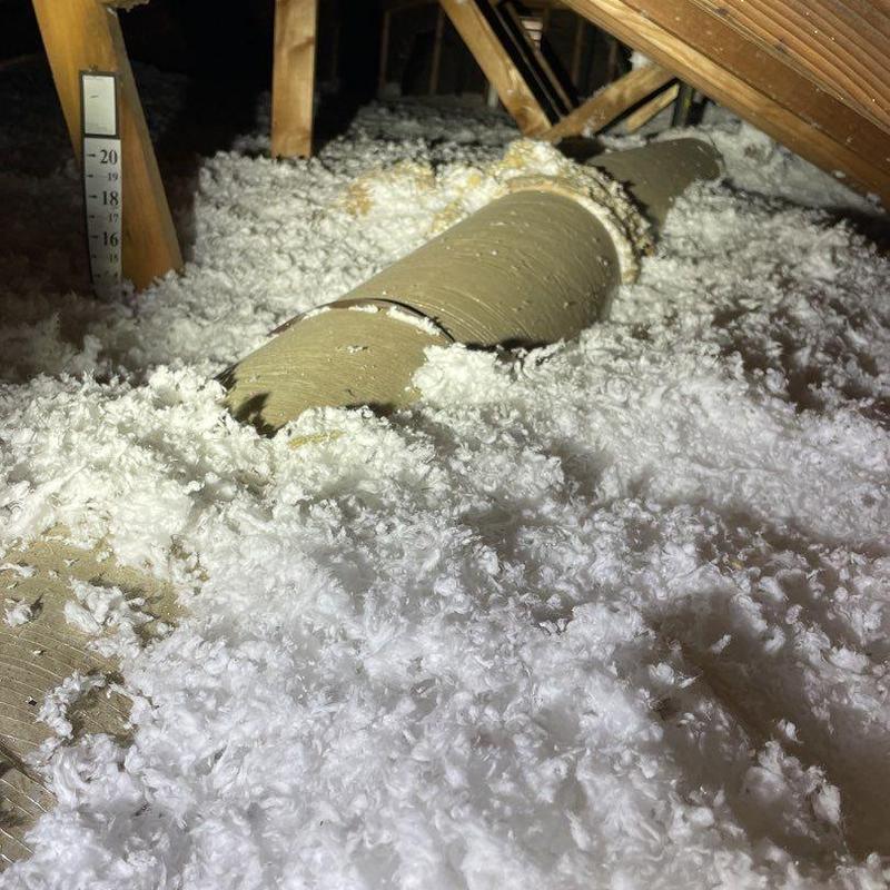 Ductwork in attic with surrounding insulation layers Ductwork in attic with surrounding insulation layers