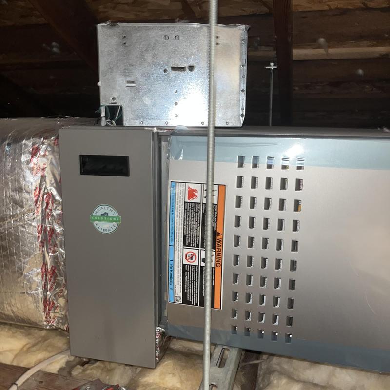 HVAC air handler unit with ductwork in attic