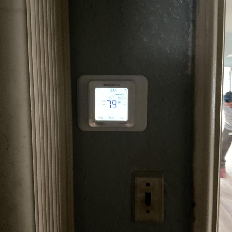 Thermostat display showing HVAC temperature settings