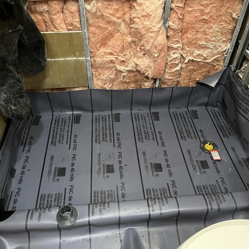 Shower pan liner installed with drain and valve fittings