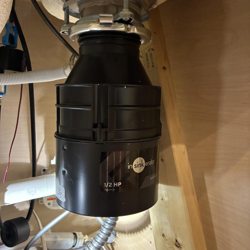 Garbage disposal unit installed under kitchen sink