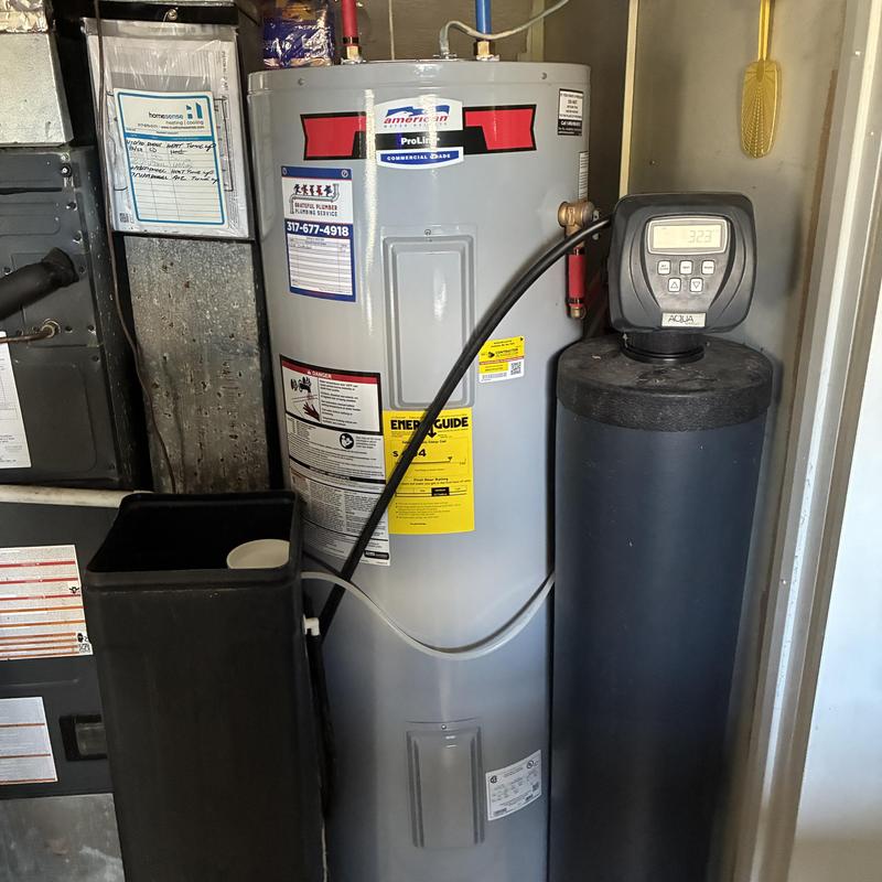 Electric water heater with water softener system installed