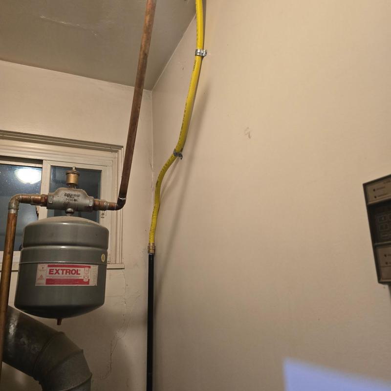 Yellow flexible gas line running to boiler system