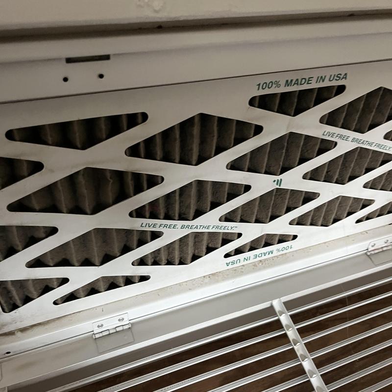 HVAC air filter with dust buildup inside vent grille