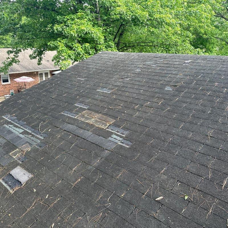Asphalt shingle roof with hail damage patches