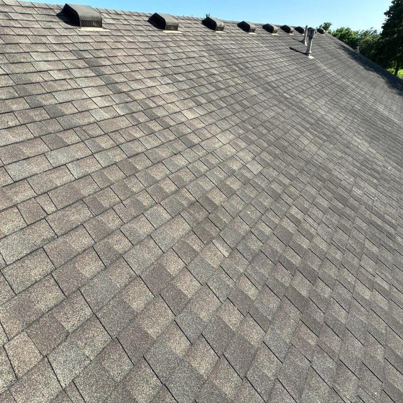 Asphalt shingle roof with vents after storm inspection