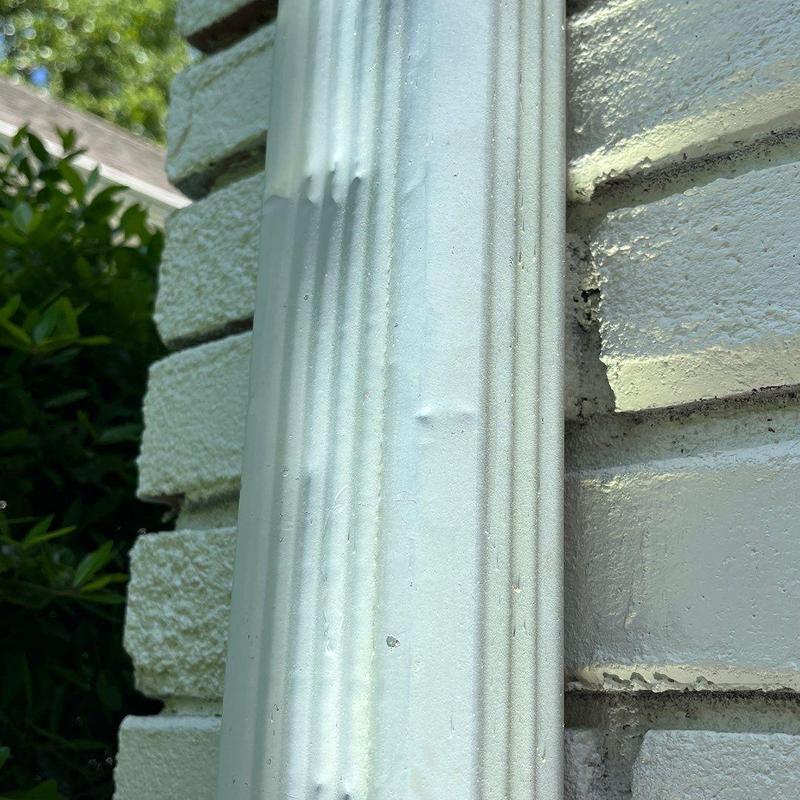 Exterior door trim with dented paint close-up