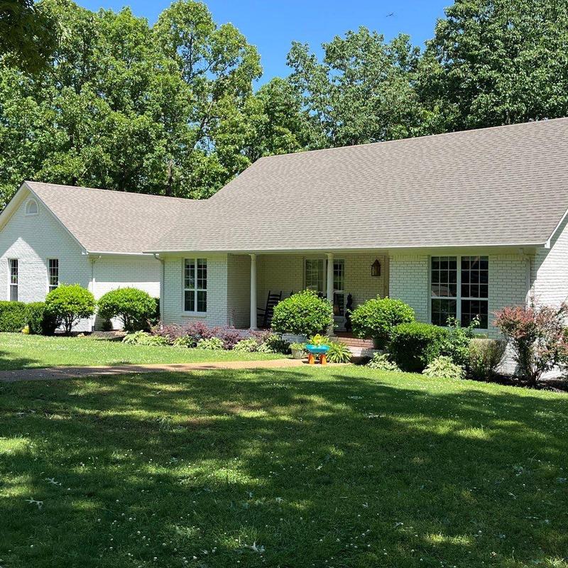 Asphalt shingle roof with porch and landscaping