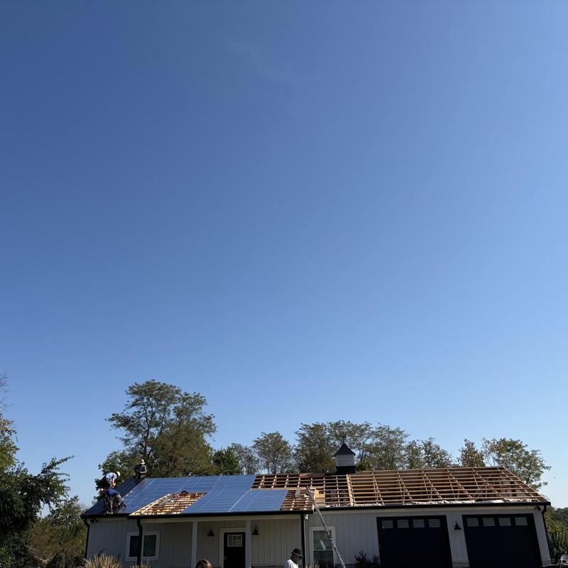 Roof deck with installed metal panels under clear sky