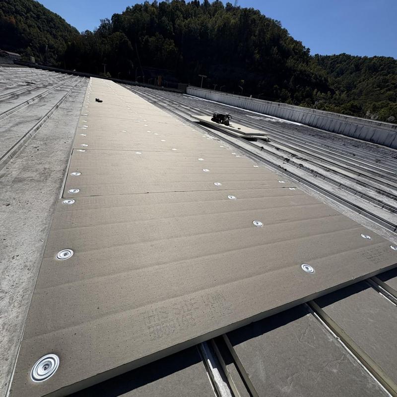 Roof deck insulation board installed on metal roof