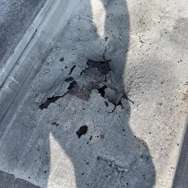 PVC membrane roof with cracked and damaged surface