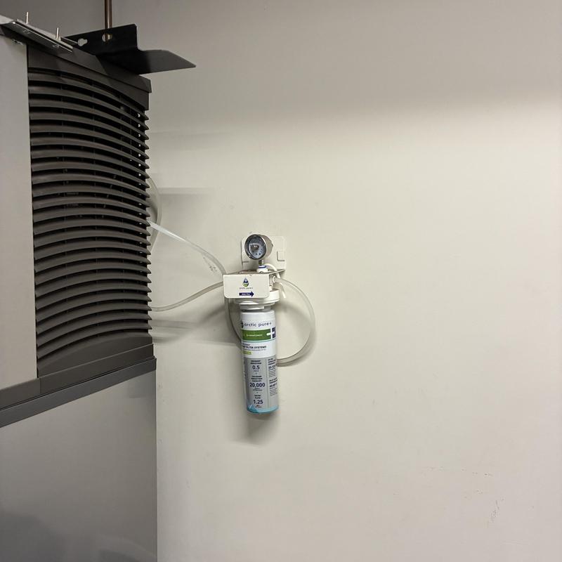 Ice machine water filter system with gauge on wall