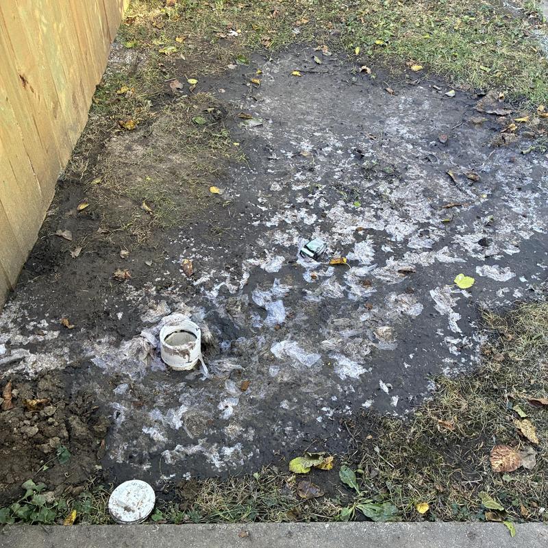 Sewer line access pipe in frozen backyard soil
