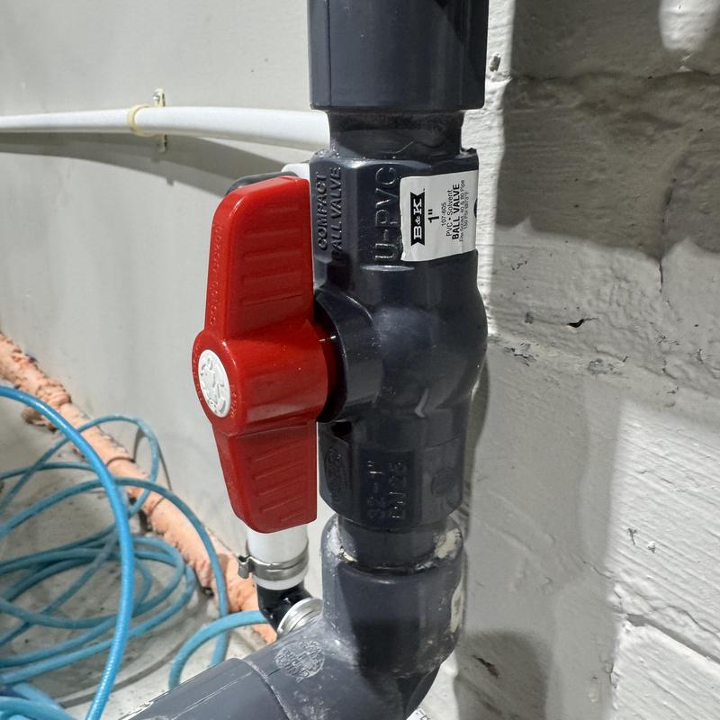 1 inch sch 80 PVC ball valve with red handle installed