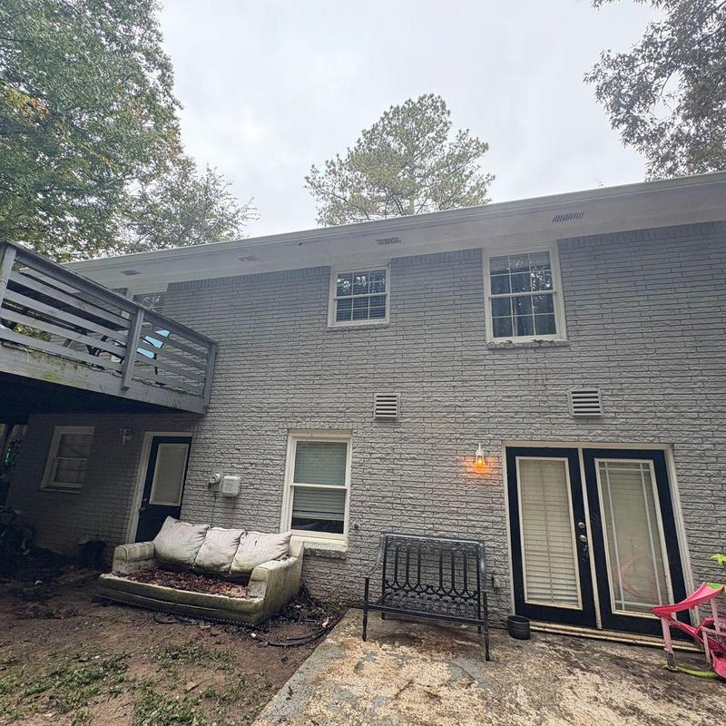 White 6 gutters on two-story brick house exterior