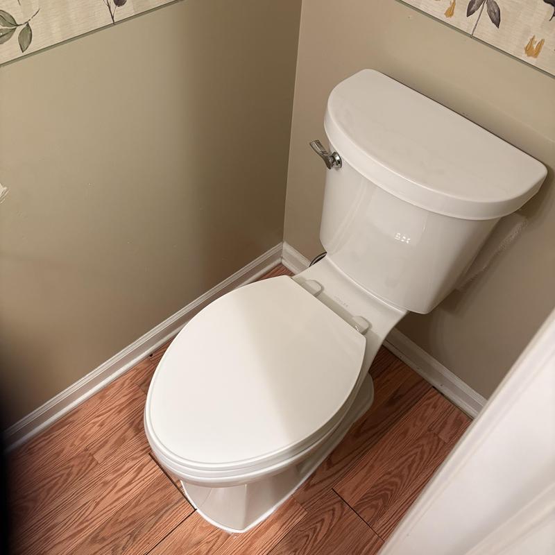 Toilet installation in residential bathroom corner
