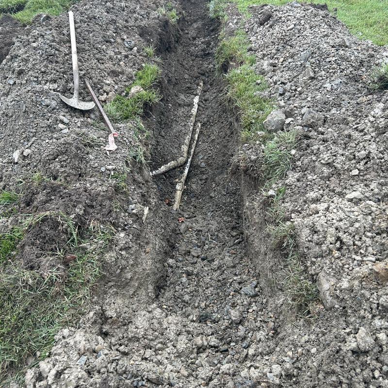 2-inch PVC water main pipe in open trench repair site