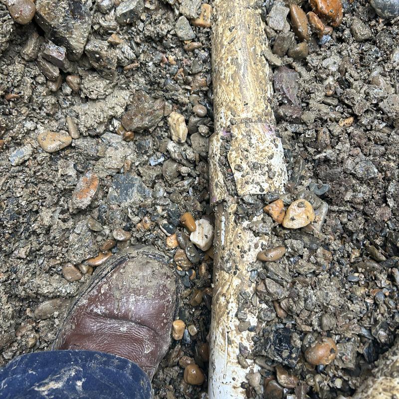 2-inch PVC water main pipe in gravel trench