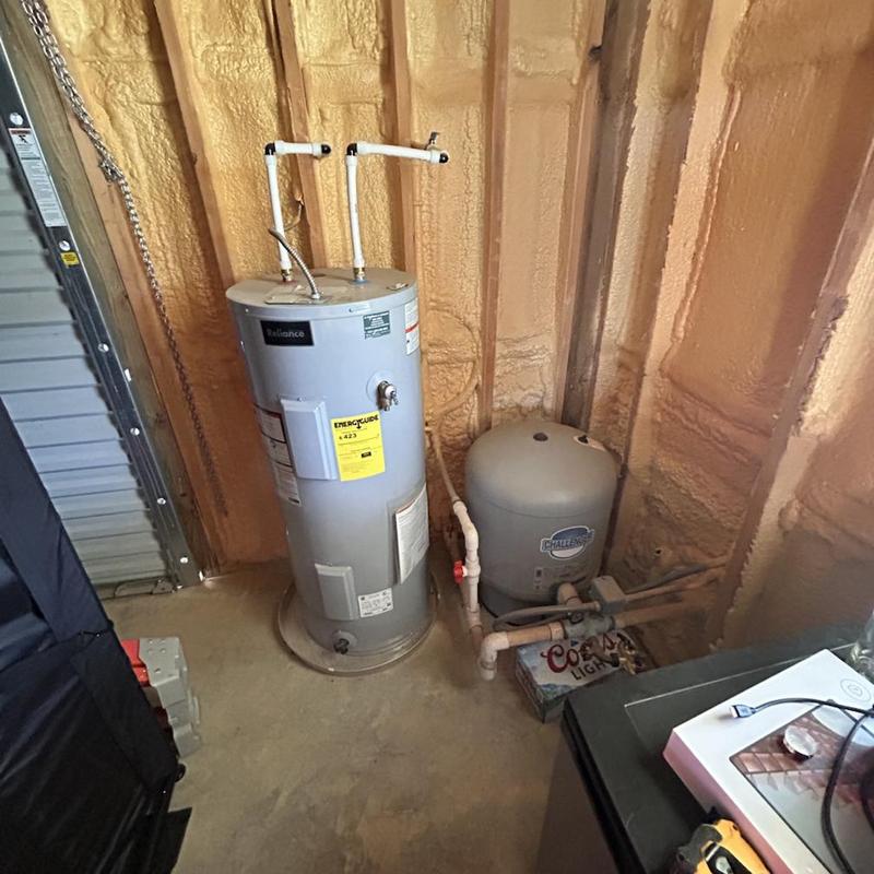 Water heater system with pipes in unfinished basement