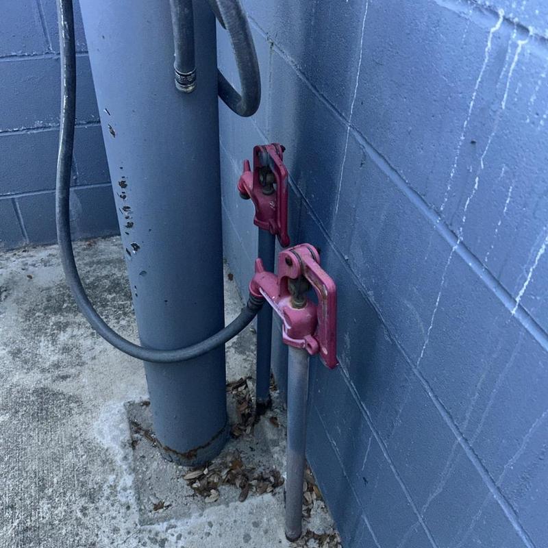 Backflow prevention valves with connected pipes against wall