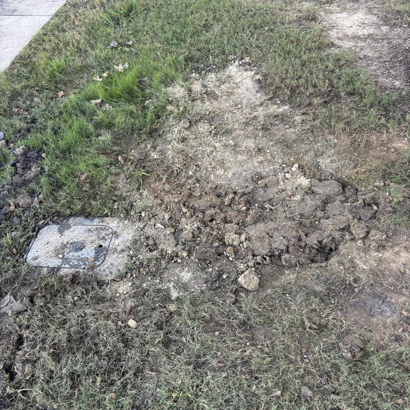 Main supply line excavation with valve cover in lawn