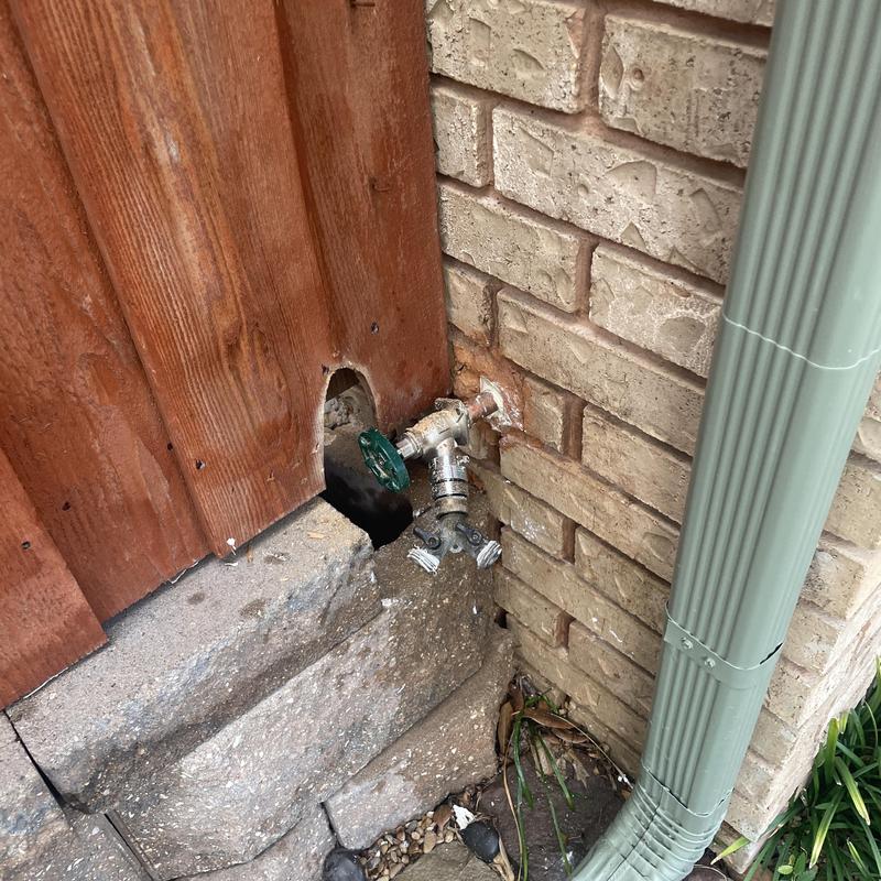 Outdoor spigot hose bib replacement next to brick wall