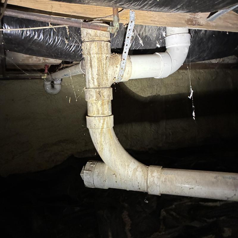 Main drain pipe with pipe damage under house crawlspace