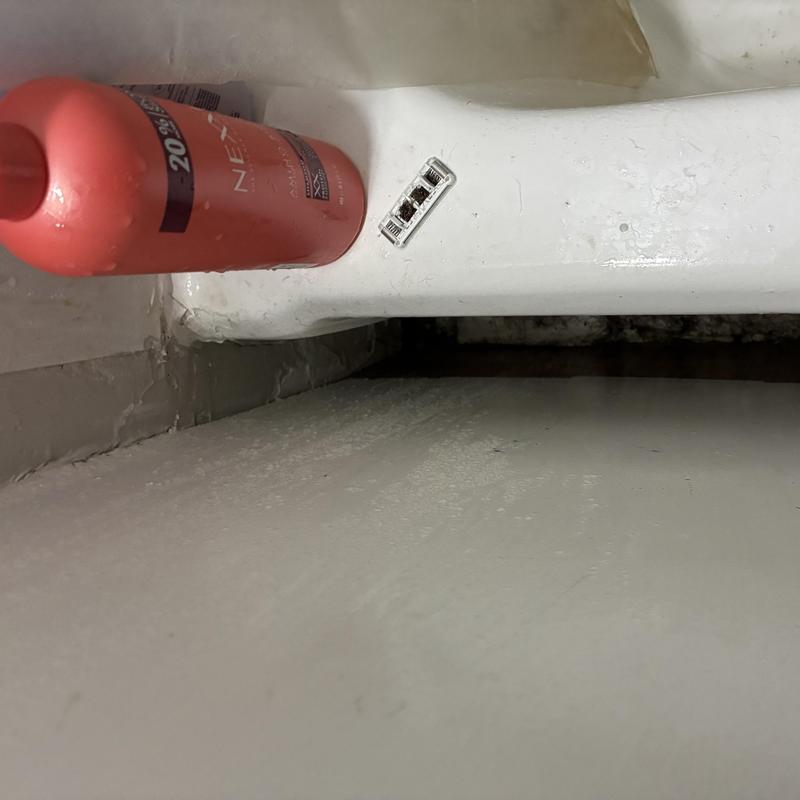 Bathtub drain with moisture and potential leak signs