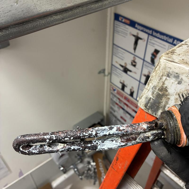 Electric water heater heating element with corrosion buildup