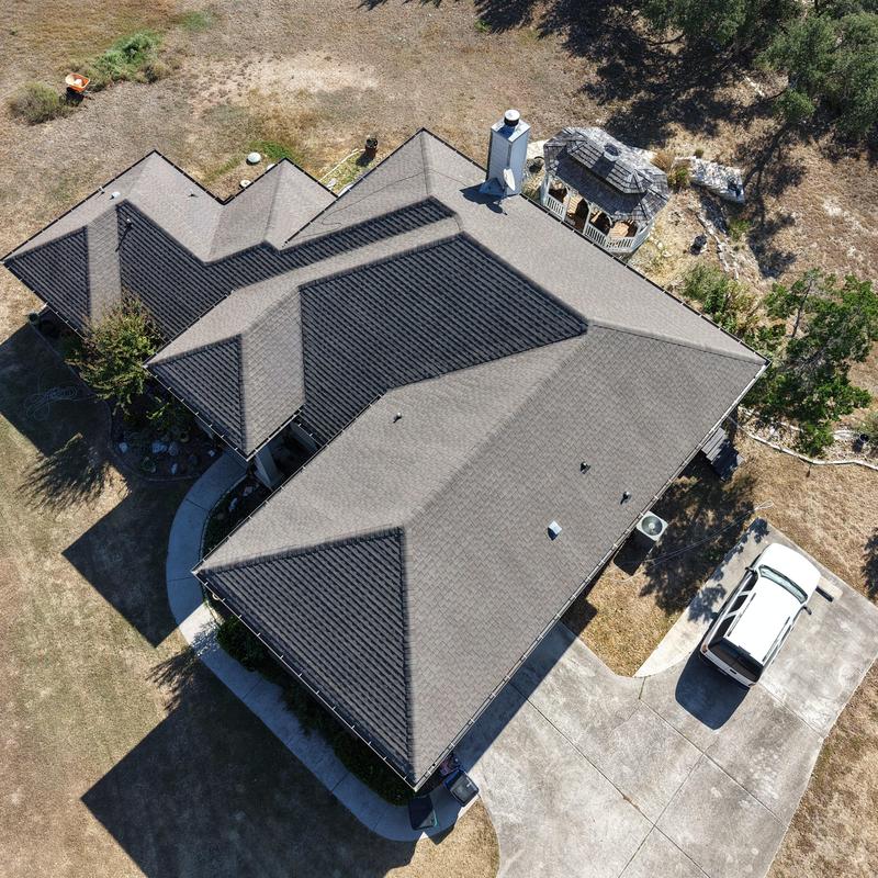 Asphalt shingle roof with visible hail damage spots