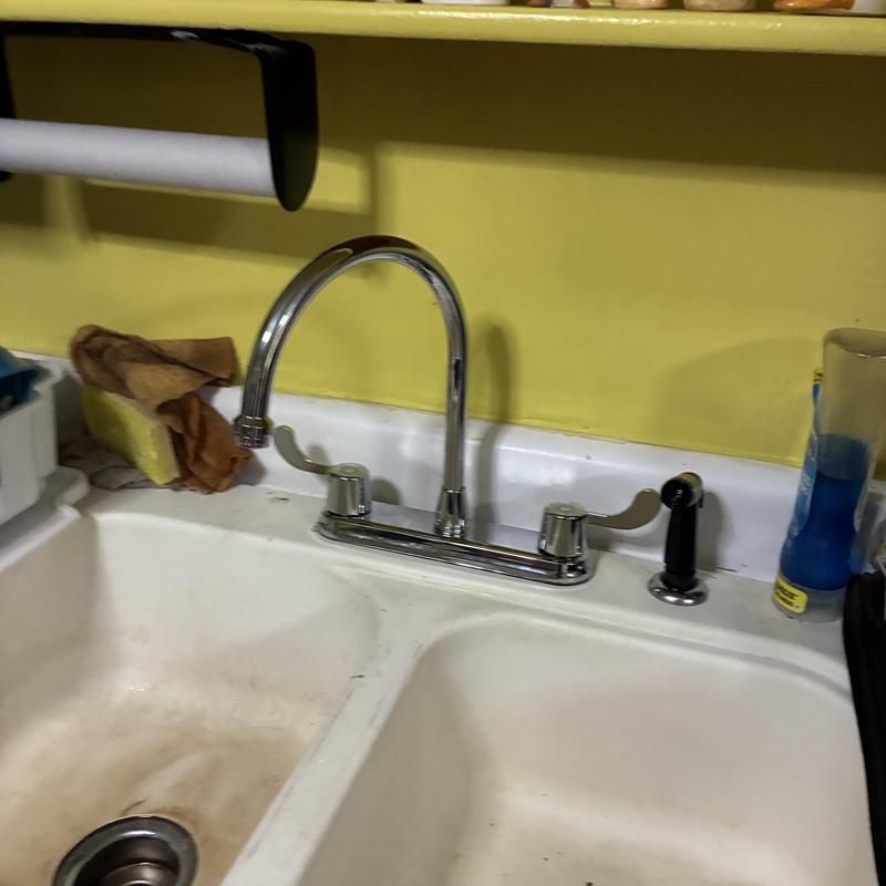 Kitchen faucet with dual handles and sprayer installed