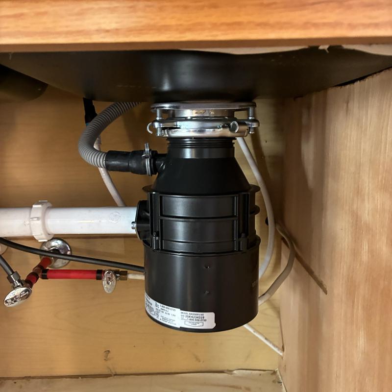 Garbage disposal unit installed under kitchen sink