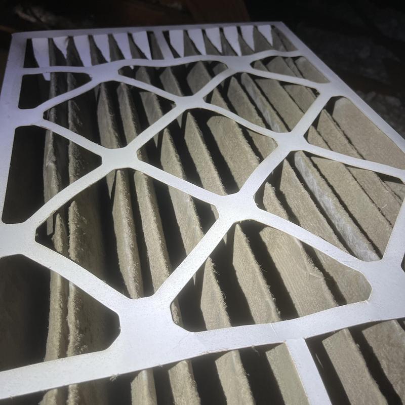 HVAC air filter clogged with dust and debris