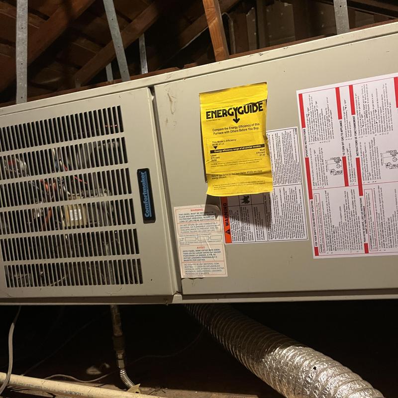 Air handler unit with EnergyGuide label in attic