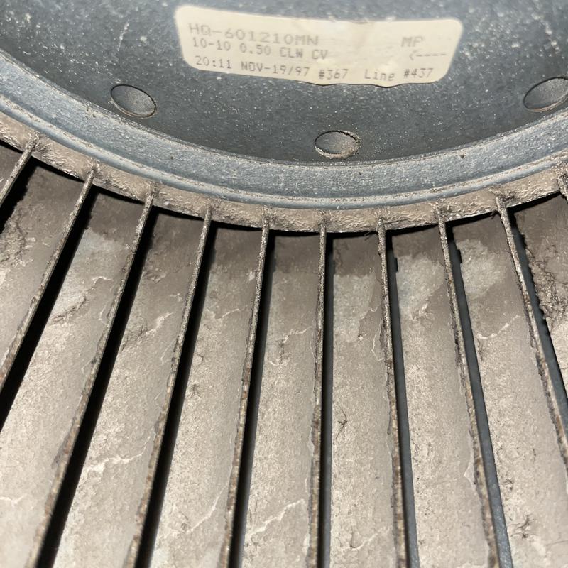 AC blower wheel with dust buildup close-up before cleaning