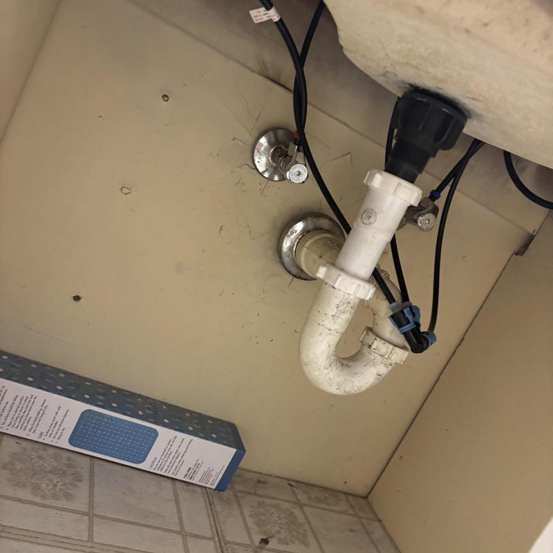 Bathroom sink drain trap under cabinet with water lines